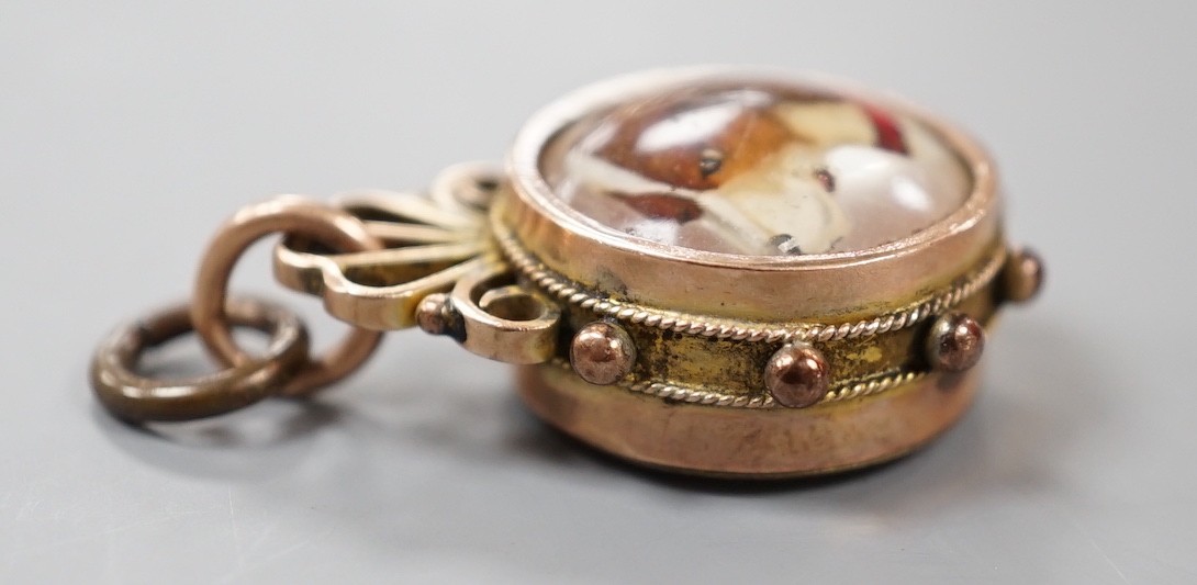 A late Victorian 9ct gold mounted Essex crystal and compass set fob, 25mm, the crystal decorated with the head of a dog.
